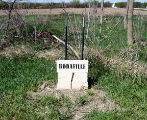 bodaville limestone sign curving gravel road in background